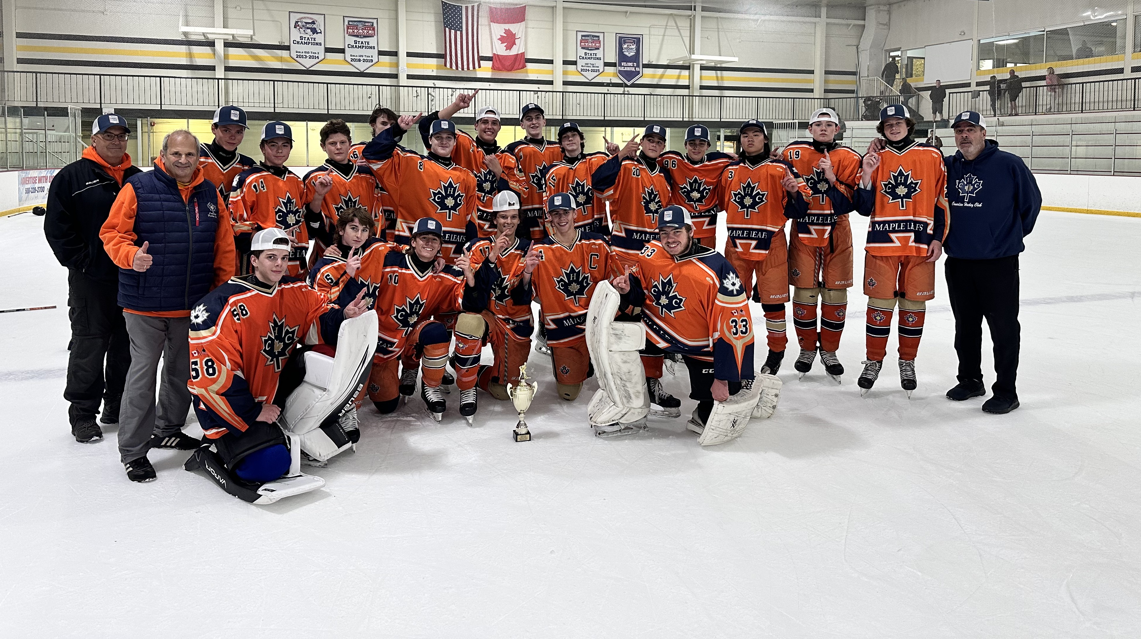 CHC Maple Leafs team photo in the locker room with a championship trophy